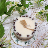 Large coffee candle burning with coffee beans on vintage teacup Beauty Scents