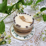 Large coffee candle burning with coffee beans on vintage teacup Beauty Scents