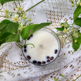 Large glass coffee bean candle lifestyle shot showing elegant glass container design