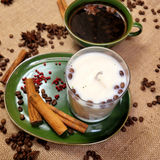Close-up detail of large glass coffee bean candle showing coffee beans embedded in wax
