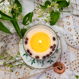 Top view of large glass coffee bean candle after 3 hours burning showing wax pool formation