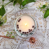 Newly lit large glass coffee bean candle top view in natural daylight