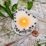Large heart coffee bean candle burning showing gentle flame and romantic ambiance