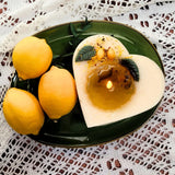 Heart-shaped candle and lemon on a decorative plate
