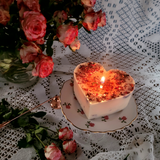 Large heart-shaped rose petals scented candle with crushed dried flowers on antique rose-patterned china - Beauty Scents handmade soy candle