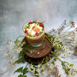 Large glass raspberry candle alternative angle displaying red wax berries in glass container