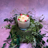 Large glass raspberry candle final angle view showing handmade soy wax with red berry decorations