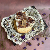 Large heart rose petal candle from above showing 9cm diameter and dried rose petal decoration