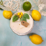 Handmade large lemon candle with natural botanicals - artisan soy wax candle with love tag styled with luxury accessorie
