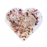 Close-up detail of real dried rose petals decoration on large heart-shaped soy candle surface