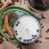 Close-up detail of small glass coffee bean candle showing coffee beans in glass container
