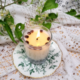 Small glass coffee bean candle lifestyle shot with natural lighting and glass design