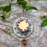 Small glass coffee bean candle burning progress showing wax pool in glass container