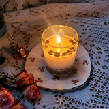 Small glass coffee bean candle artistic shot showing coffee beans in glass design