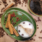 Small glass coffee bean candle angle view with coffee beans decoration