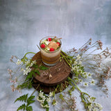 Small glass raspberry candle top view showing red berry arrangement in glass container