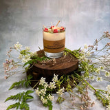 Small glass raspberry candle final angle view showing handmade soy wax with red berry decorations
