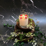 Small glass raspberry candle close-up showing red wax berry decorations in clear glass container