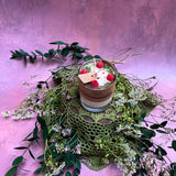 Small glass raspberry candle alternative view highlighting red wax berry decorative elements