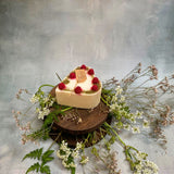 Small heart raspberry candle final angle view showing handmade soy wax with red berry decorations