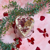 Small heart soy candle with rose petals in gift setting, perfect romantic present