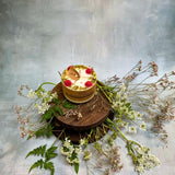 Small raspberry candle alternative angle displaying red wax berries and handmade quality