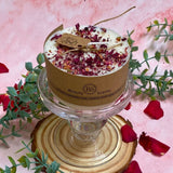 Small 5cm height soy wax candle decorated with shredded rose petals, kraft packaging, displayed on crystal pedestal with romantic styling