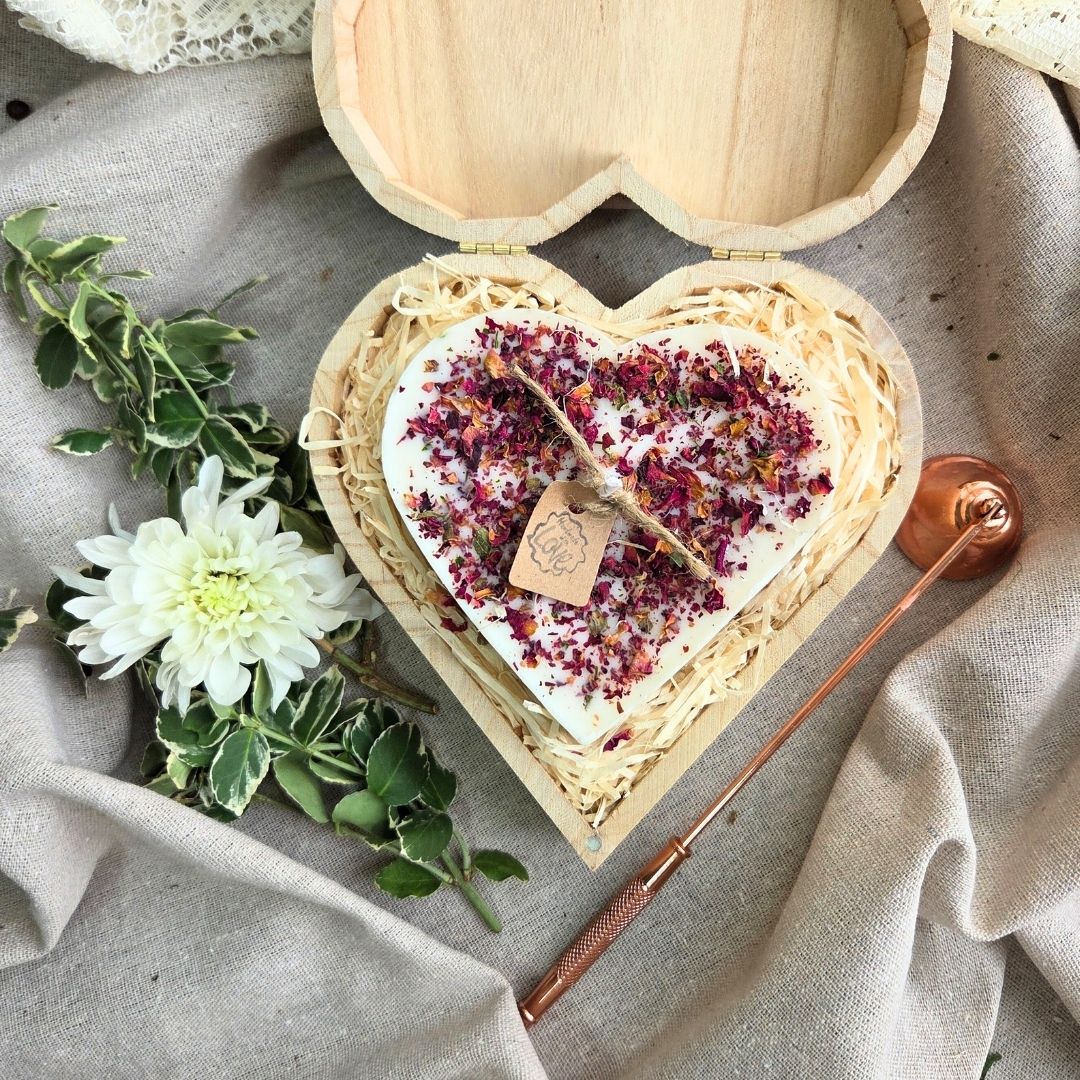 Close-up of rose petal heart candle in eco-friendly wooden box