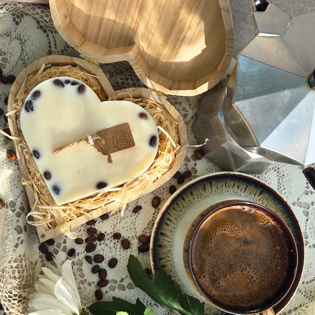 Close-up of handmade heart candle with coffee beans in wooden box, artisan country-style design
