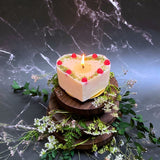 Large heart raspberry candle overhead shot displaying berry decorations and heart shape