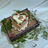 Large heart raspberry candle top view highlighting red berry arrangement on heart candle