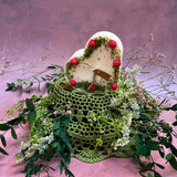 Large heart raspberry candle close-up showing red wax berry decorations and romantic heart shape