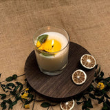 Small glass lemon candle burning showing flame and wax pool - Verbena Lemon Grass scented candle