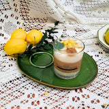 Candle with lemons on a green plate on a lace tablecloth