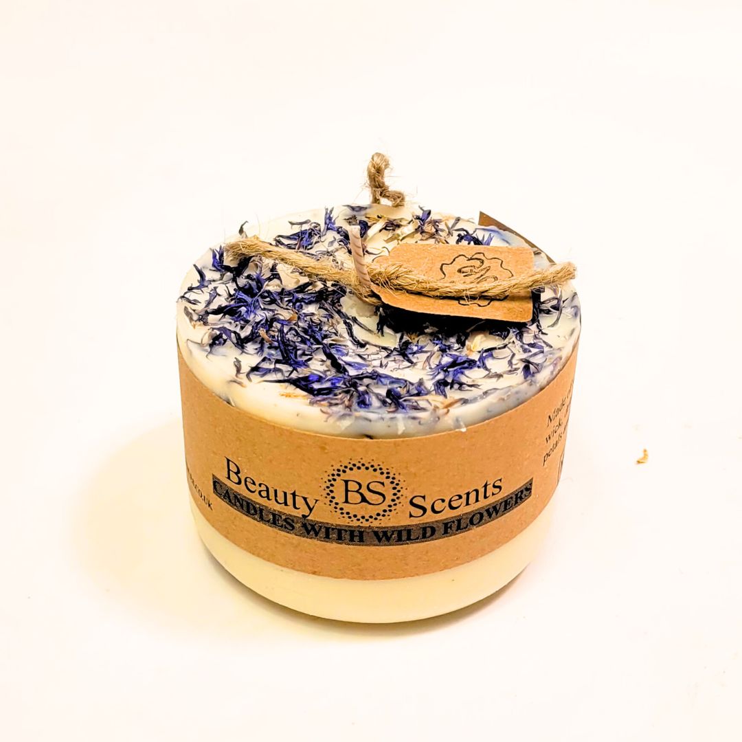 Candle with wildflower petals and 'Beauty Scents' label on a white background