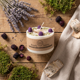 Candle with natural elements on a wooden surface, featuring 'Beauty Scents' branding.