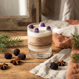 Glass candle with blackberries and star anise on a wooden surface, branded 'Beauty Scents'.
