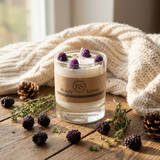 Candle with blackberries and pinecones on a wooden surface, branded 'FS Beauty Scents'.