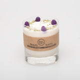 Candle with purple flowers on a white background, branded 'Beauty Scents'.