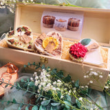 3 Hearts Winter Gift Set wooden box open view showing three heart-shaped candles with winter botanical decorations nestled in natural wood shavings