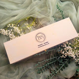 3 Hearts Winter Gift Set lifestyle shot with white flowers and soft green textile background showing romantic winter gift presentation