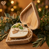 Beauty Scents Heart Apple Candle in a wooden box with greenery around on a wooden table