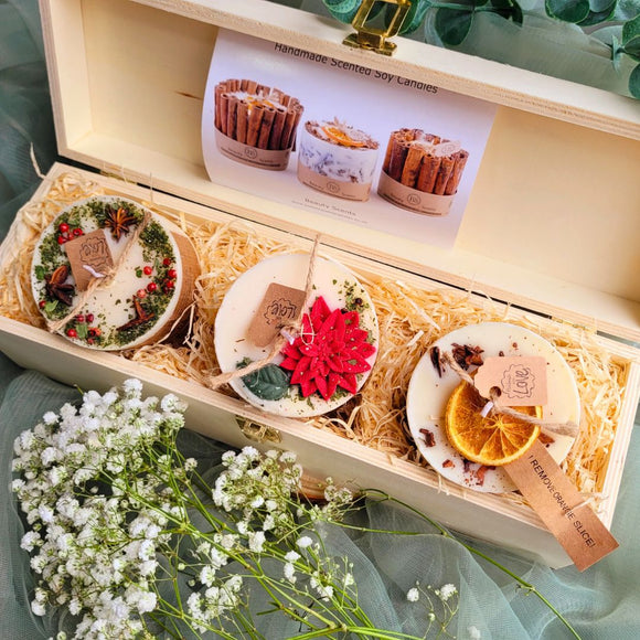 Gift Set 3 Winter Small Candles wooden box lifestyle shot with white flowers and green textile background showing premium gift presentation