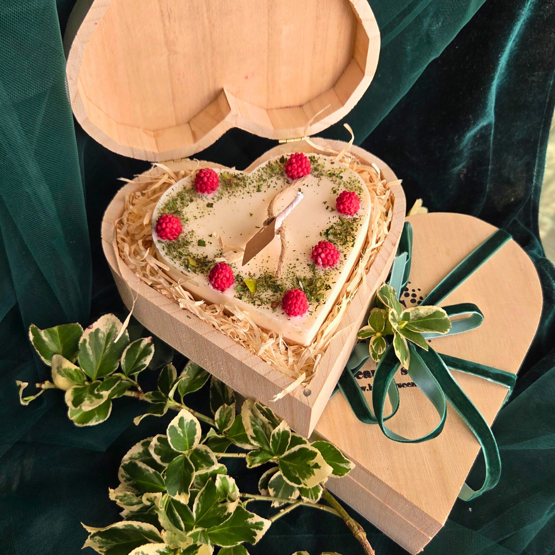Close-up of raspberry heart candle in eco-friendly wooden box