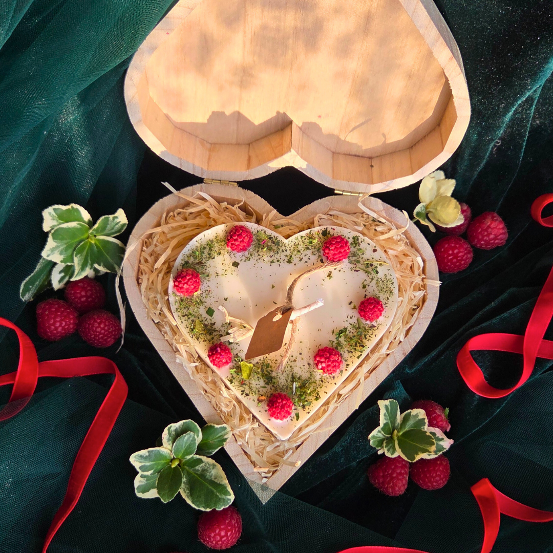 Handmade heart candle decorated with raspberries, set in rustic wooden box