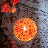 Handcrafted large glass rose petals candle with warm flame styled on vintage floral china with lace and fresh pink roses