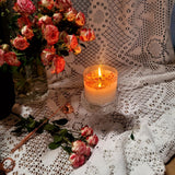 Large glass container rose petals scented candle burning with golden flame on antique rose-patterned china - Beauty Scents handmade soy candle