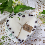 Side view of large heart coffee bean candle showing natural coffee beans embedded in wax