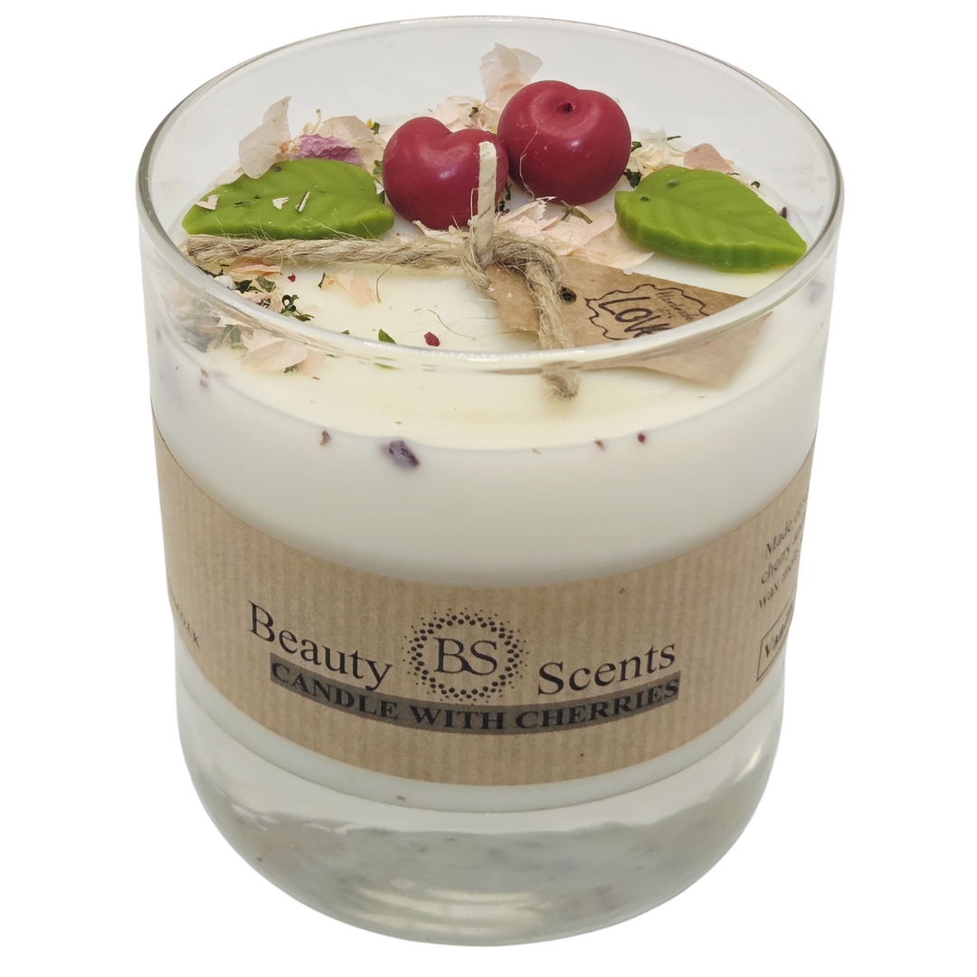 Large soy candle in a clear glass jar with wax cherries and green leaf decoration, with tag and ‘Candle with Cherries’ label, on a white background.
