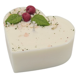 Heart-shaped candle with wax cherries green leaf on a white background